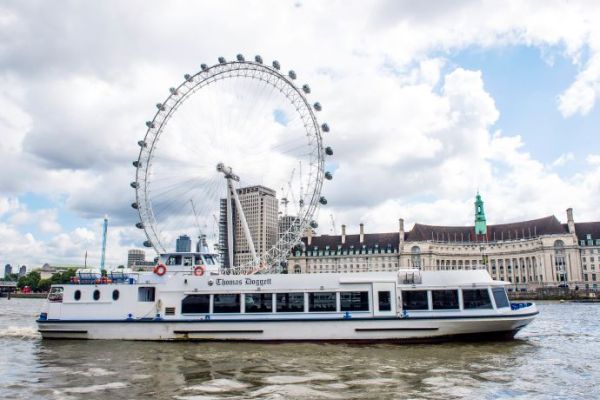 The Thomas Doggett river boat on the Thames in front of the London Eye