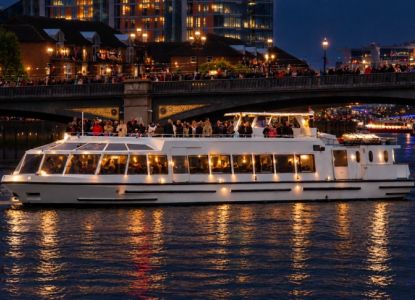 Sarpedon New Year's Eve cruise on the River Thames in London, featuring a glass-enclosed lower deck and an open-air upper deck.