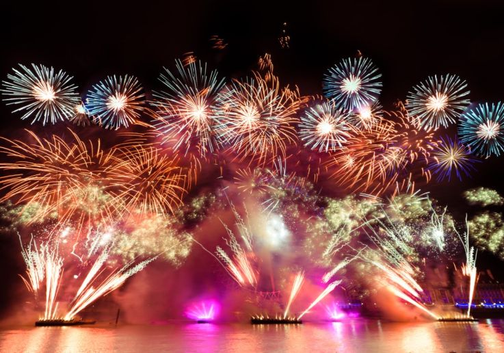 Fireworks launched from barges on the Thames