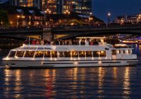 Sarpedon New Year's Eve cruise on the River Thames in London, featuring a glass-enclosed lower deck and an open-air upper deck.