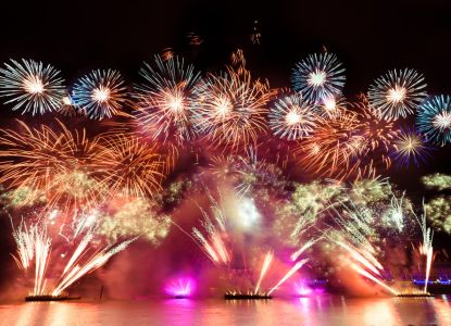 Fireworks launched from barges on the Thames