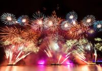 Fireworks launched from barges on the Thames
