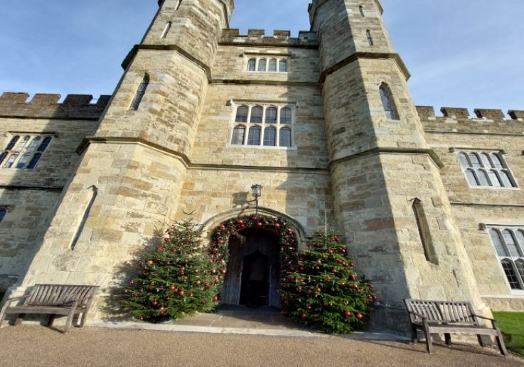 Leeds Castle entrance with decorated Christmas trees on the Boxing Day tour from London
