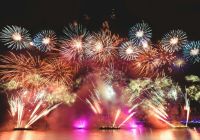 Fireworks launched from barges over the water