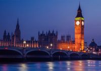 Big Ben and the Houses of Parliament lit up at dusk, with Westminster Bridge over the Thames